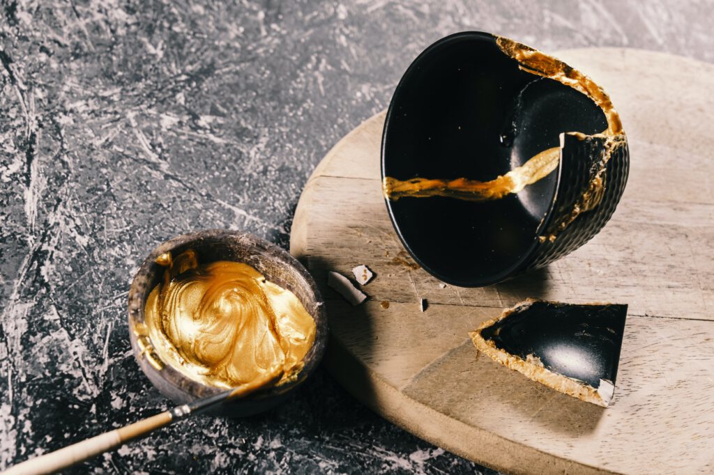 Bowl with a golden ointment to repair a pottery for the practice of kintsugi art.