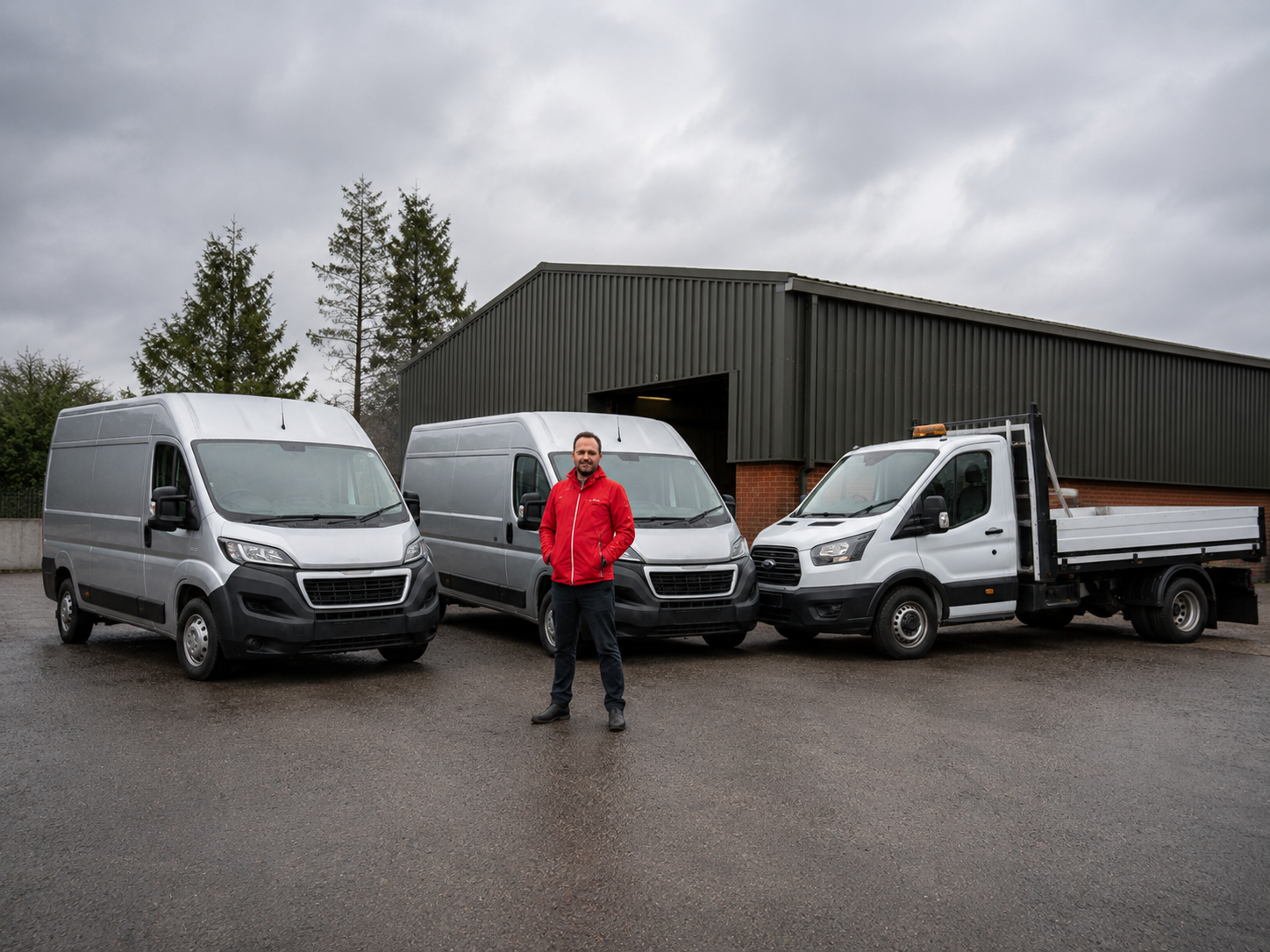 Peter Ellis standing with courier vans ready for local and national delivery work